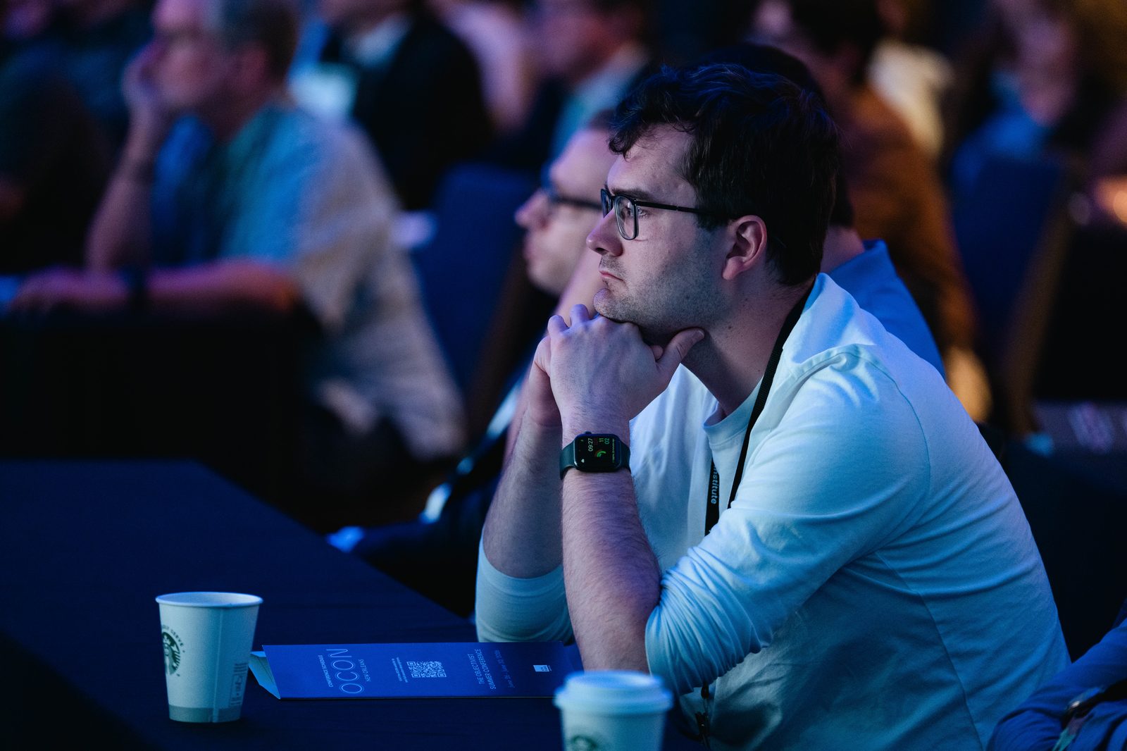 A member listening closely at a conference session